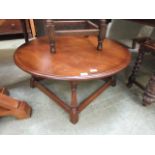 A reproduction circular oak occasional table on square supports