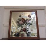 A wooden framed bevel glass mirror with hand painted floral design