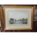 A modern framed and glazed watercolour of river and church scene signed bottom left John