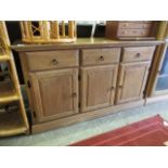 A modern sideboard, three drawers over three panel cupboard doors