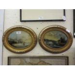 A pair of gilt oval framed possible oil paintings of continental lake scenes