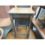 An early 20th century stained wooden occasional table on barley twist supports