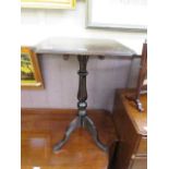 A mahogany tilt top tripod table