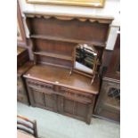 A mid-20th century oak dresser having plate rack to top, the base having two drawers above