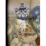 A clog along with a Delft ceramic clog with windmill design and a blue and white Delft vase with