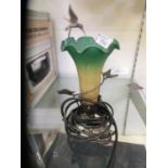 A glass and metalwork desk lamp with hummingbird and flower design