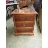 A yew veneered bedside chest of three drawers