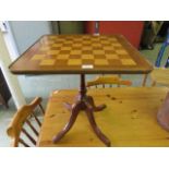 A reproduction occasional table with chess board to top