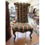 A Victorian walnut framed prayer chair upholstered in a striped fabric