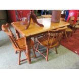 A modern pine kitchen table with a set of four matching chairs