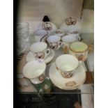 A selection of ceramic coronation ware to include cups, saucers, and a twin handled mug