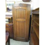 A mid-20th century oak linen fold hall cupboard