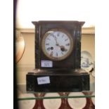 A black slate and marble mantle clock