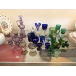 A large selection of mostly coloured glassware to include small decanter, drinking glasses, mug,