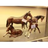 Four Beswick ceramic models of two bay horses, and two bay foals