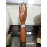 A wooden hand with movable thumb