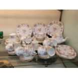 A selection of Royal Albert ceramic ware with floral crochet design comprising of cups, saucers,