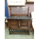 An early 20th century oak washstand with grey marble top and glass insert back