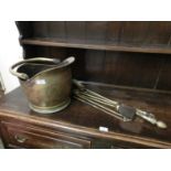 A brass coal scuttle and companion set