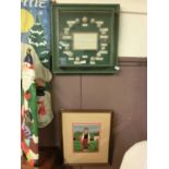 A framed and glazed golf ball display along with a framed needlework of golfer