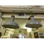 A pair of industrial grey ceiling hanging light fittings