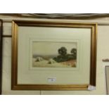 A framed and glazed watercolour of harvest scene