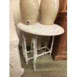 An early 20th century white painted drop-leaf table