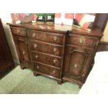 A reproduction flame mahogany break front side cabinet