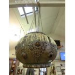 An eastern spherical pierced metal and glass ceiling hanging light fitting