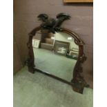 A 19th century carved mahogany mirror surmounted by an eagle (from an item of furniture)