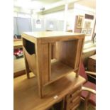 A mid-20th century oak veneered occasional table with magazine racks to sides