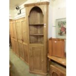 A pine floor standing corner cupboard