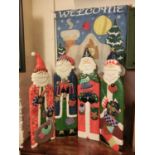 A four-fold santa themed screen along with a 'Welcome' tapestry
