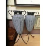 A pair of metal and wicker vases