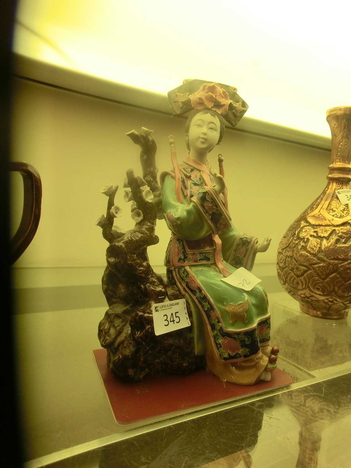 A Japanese ceramic figurine of seated lady with associated paperwork