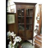An Edwardian mahogany, boxwood strung, and banded floor standing corner cupboard