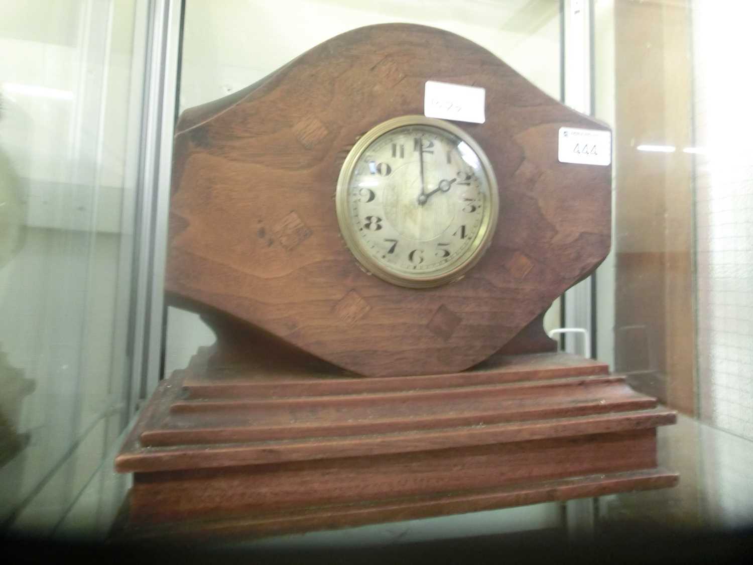 An early 20th century mantle clock made from a wooden propeller on a base