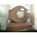 An early 20th century mantle clock made from a wooden propeller on a base