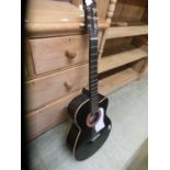 A black painted acoustic guitar