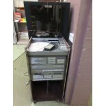 A 1980s Amstrad hi-fi in cabinet with a pair of matching speakers