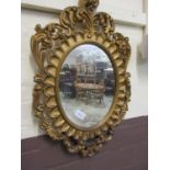 A reproduction ornate framed wall mirror
