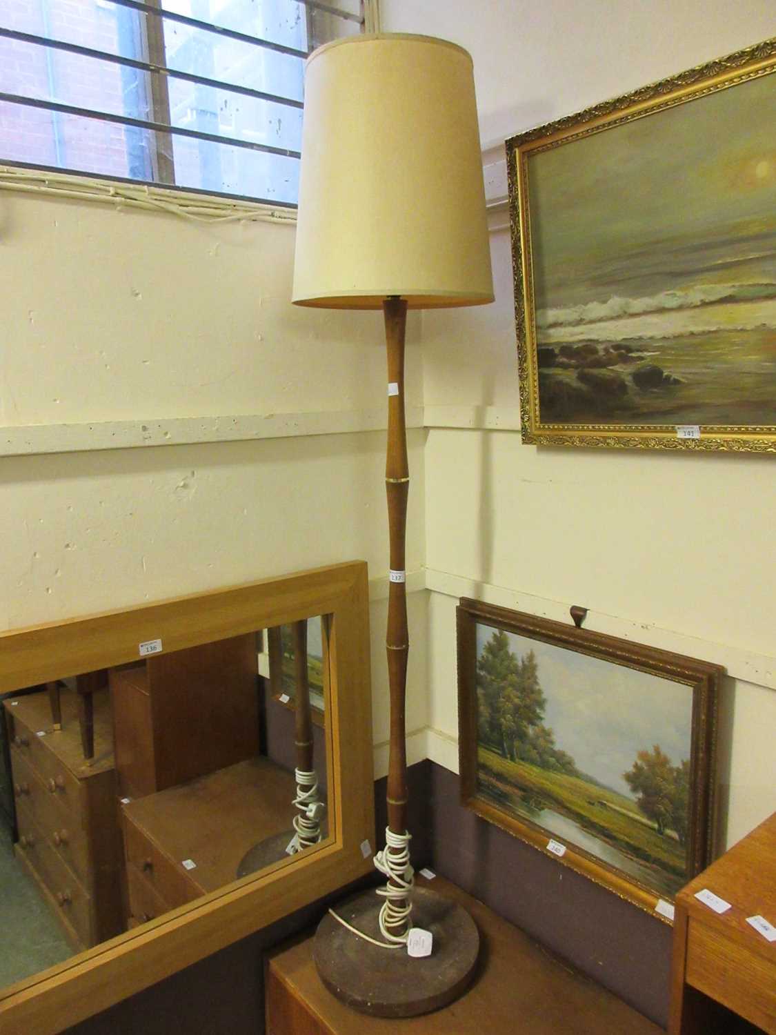 A mid-20th century teak standard lamp