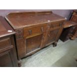 A mid-20th century oak sideboard having two drawers above a pair of cupboard doors