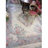 A large cream and patterned Chinese rug measuring 305cm by 240cm