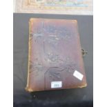 A Victorian leather bound photo album containing a quantity of photographs