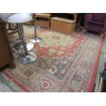 A large red patterned ground rug 350cm by 266cm