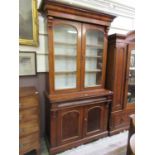 A late Victorian mahogany veneered chiffonier bookcase having a pair of glazed doors to top