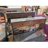 Two wooden carpenter's chests containing planes, saws, brace and bits etc.