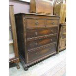 An early 20th century oak chest of two short over three long drawers