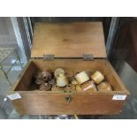 A box containing miniature earthenware pots possibly ink wells